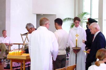 Two liver recipients lighting candles in memory of their donors.